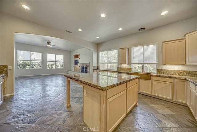 43922 Carentan Dr, Temecula, CA 92592 - kitchen with light brown cabinets, stone tile floors, open floor plan, a ceiling fan, and recessed lighting