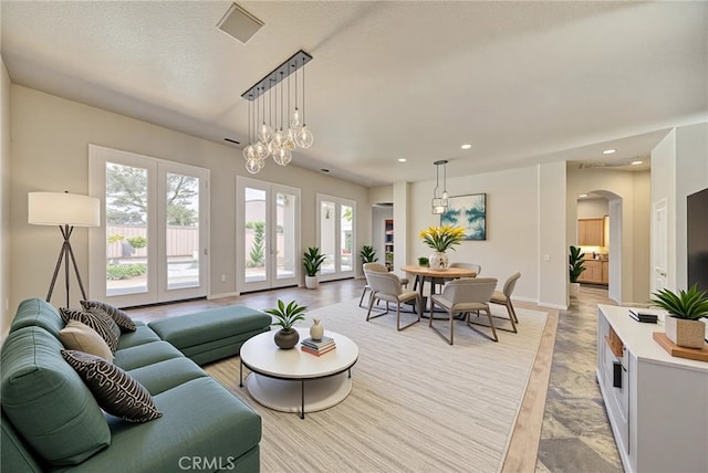 43922 Carentan Dr, Temecula, CA 92592 - living room featuring arched walkways, baseboards, and recessed lighting