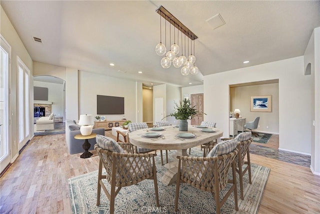 43922 Carentan Dr, Temecula, CA 92592 - dining room with light wood finished floors, arched walkways, and recessed lighting