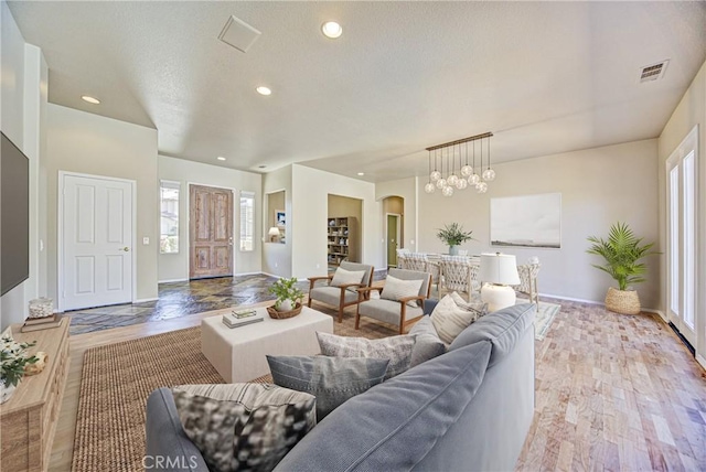 43922 Carentan Dr, Temecula, CA 92592 - living area featuring plenty of natural light, wood finished floors, recessed lighting, and arched walkways