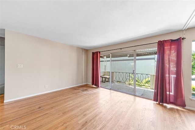 spare room with wood finished floors and baseboards