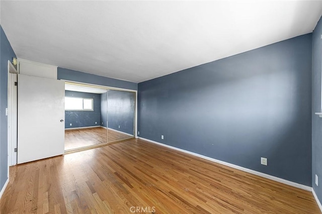 empty room with wood finished floors and baseboards