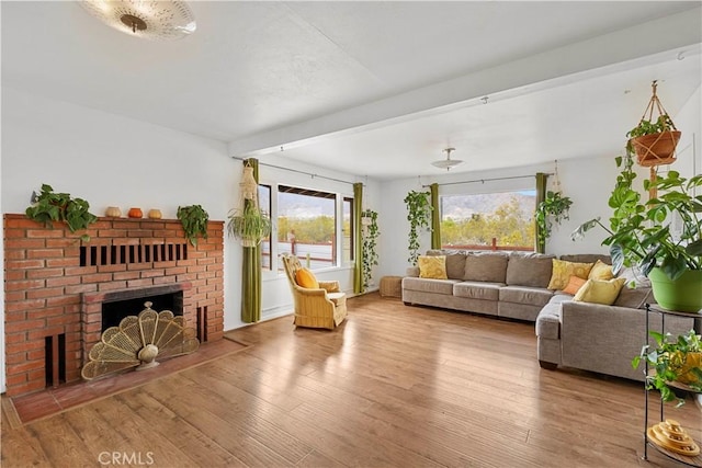 51609 Oregon Trl, Morongo Valley, CA 92256 - living room with a brick fireplace, wood finished floors, and beam ceiling