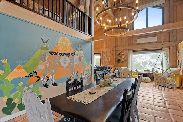 51609 Oregon Trl, Morongo Valley, CA 92256 - dining room with plenty of natural light, a chandelier, wooden walls, a towering ceiling, and tile patterned flooring