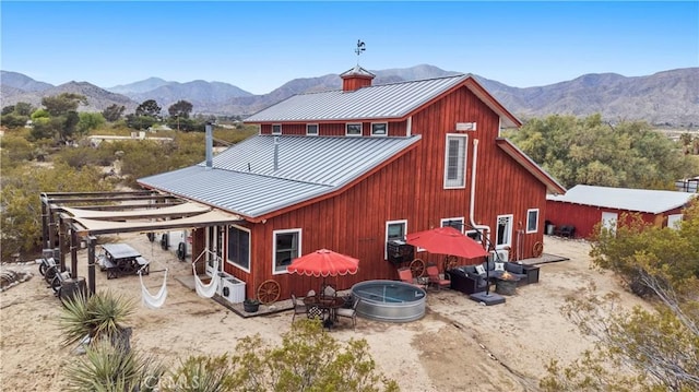 51609 Oregon Trl, Morongo Valley, CA 92256 - rear view of house with a standing seam roof, metal roof, and a mountain view