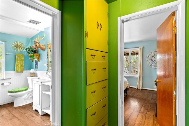 51609 Oregon Trl, Morongo Valley, CA 92256 - hall featuring wood-type flooring, plenty of natural light, wainscoting, and a sink