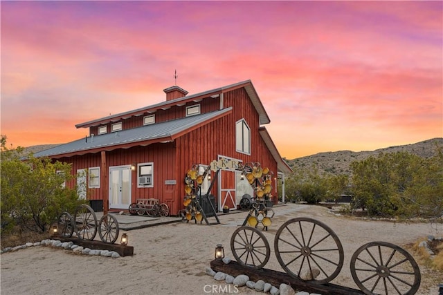 51609 Oregon Trl, Morongo Valley, CA 92256 - back of property featuring board and batten siding, metal roof, and a mountain view