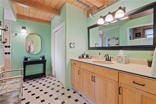 51609 Oregon Trl, Morongo Valley, CA 92256 - bathroom featuring wooden ceiling, tile patterned floors, beamed ceiling, and vanity