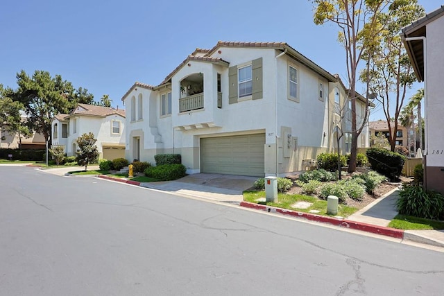 1825 Via Capri St, Chula Vista, CA 91913 - multi unit property featuring an attached garage, stucco siding, a tile roof, driveway, and a balcony