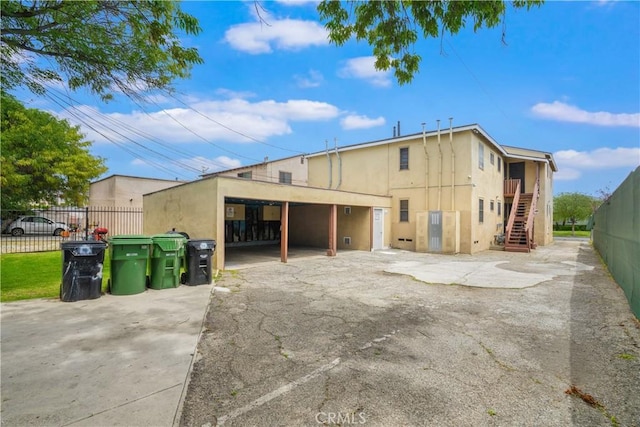 9027 Ramsgate Ave, Los Angeles, CA 90045 - back of house with stucco siding, stairway, and fence