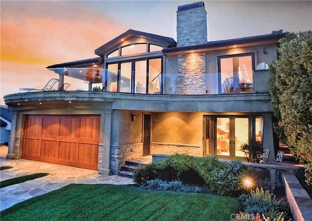 535 High Dr, Laguna Beach, CA 92651 - back of house with stone siding, a balcony, a garage, concrete driveway, and a chimney