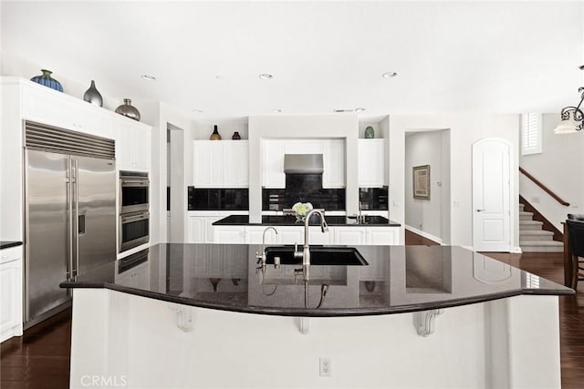 4448 St Cloud, Claremont, CA 91711 - kitchen with stainless steel appliances, a sink, a large island with sink, dark wood finished floors, and recessed lighting