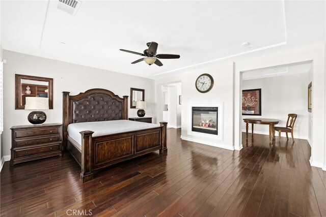 4448 St Cloud, Claremont, CA 91711 - bedroom with dark wood finished floors, baseboards, a glass covered fireplace, and ceiling fan
