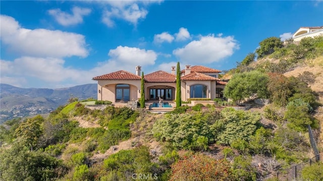 7811 Camino De Arriba, Rancho Santa Fe, CA 92067 - rear view of property featuring a chimney, french doors, stucco siding, a tile roof, and fence