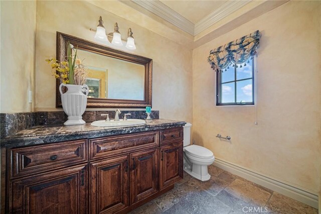 7811 Camino De Arriba, Rancho Santa Fe, CA 92067 - bathroom featuring ornamental molding, vanity, toilet, stone tile flooring, and baseboards