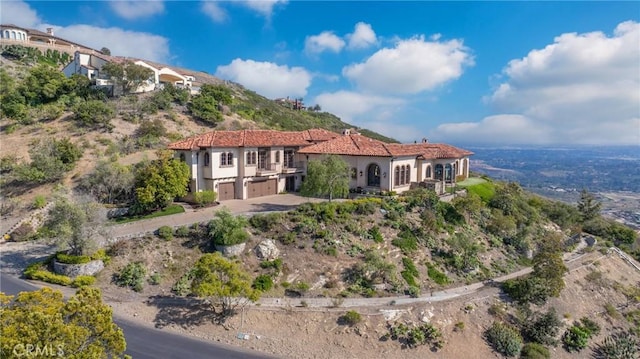 7811 Camino De Arriba, Rancho Santa Fe, CA 92067 - rear view of house with an attached garage, stucco siding, and driveway