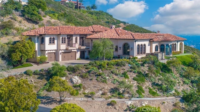 7811 Camino De Arriba, Rancho Santa Fe, CA 92067 - view of front facade featuring a garage, stucco siding, driveway, and a chimney