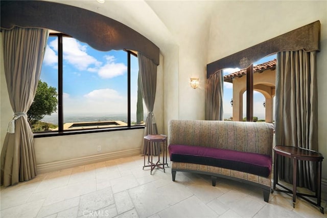 7811 Camino De Arriba, Rancho Santa Fe, CA 92067 - bedroom with baseboards, arched walkways, and stone tile floors