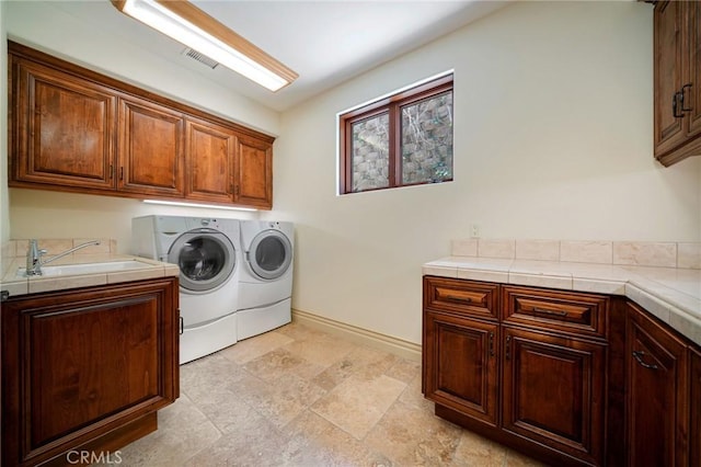 7811 Camino De Arriba, Rancho Santa Fe, CA 92067 - washroom featuring cabinet space, separate washer and dryer, baseboards, and light stone finish flooring