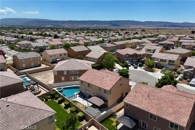 aerial perspective of suburban area with a pool area and mountains