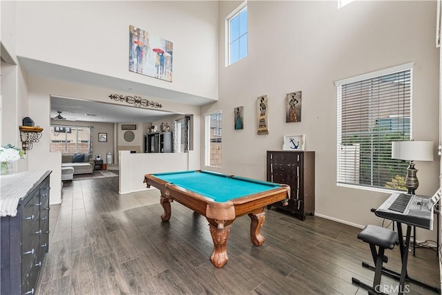 rec room with dark wood-style flooring, pool table, a towering ceiling, and baseboards