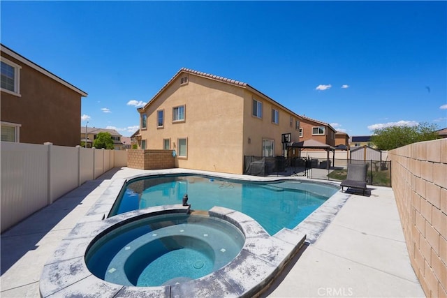 view of swimming pool featuring a gazebo, a pool with connected hot tub, a fenced backyard, and a residential view