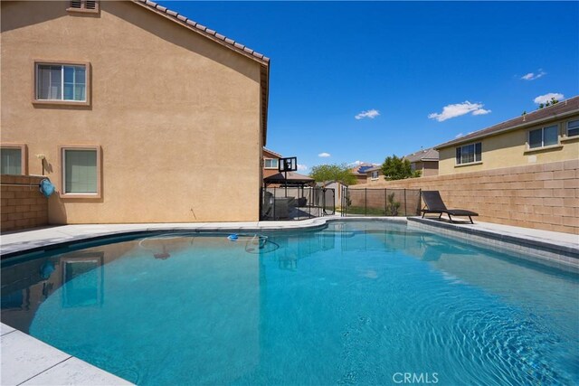 view of swimming pool with a fenced backyard