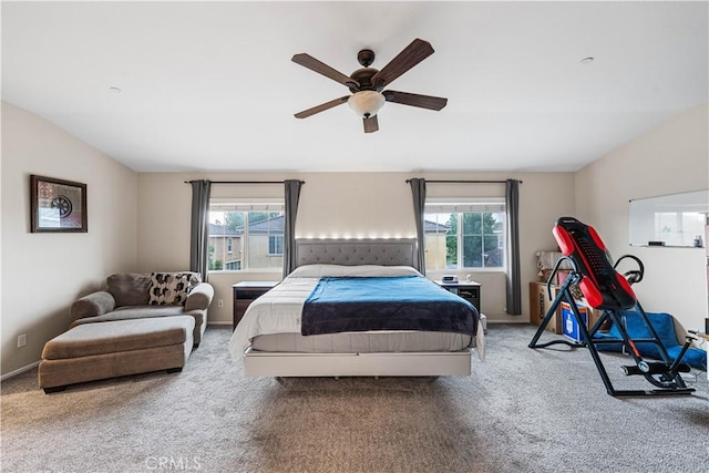 bedroom with carpet floors, multiple windows, lofted ceiling, baseboards, and a ceiling fan