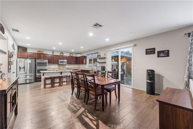 dining area featuring recessed lighting and wood finished floors