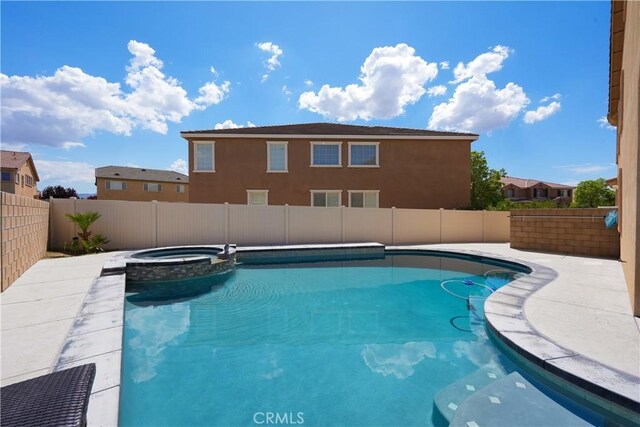 view of pool featuring a fenced backyard and a pool with connected hot tub