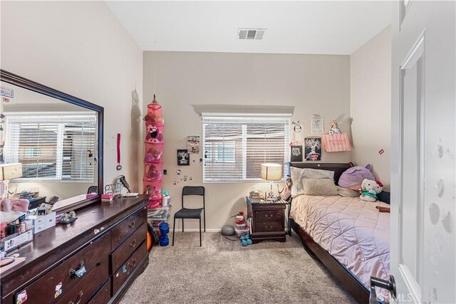 bedroom featuring light carpet and baseboards