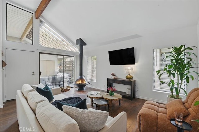 living area with a wood stove, baseboards, and wood finished floors