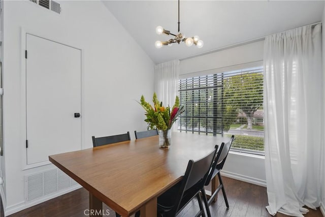dining space with a chandelier, wood finished floors, plenty of natural light, lofted ceiling, and baseboards