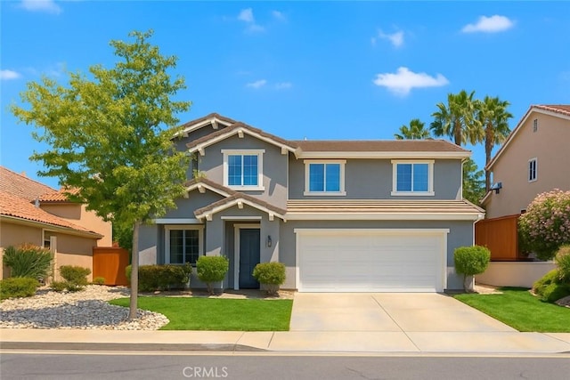 view of front of home featuring an attached garage, concrete driveway, stucco siding, and fence