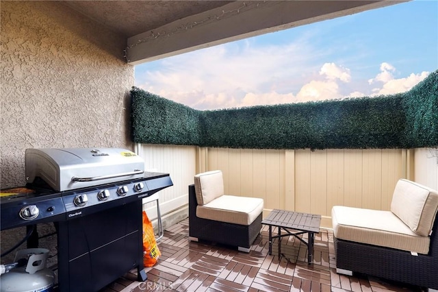 view of patio featuring grilling area, a wooden deck, and fence