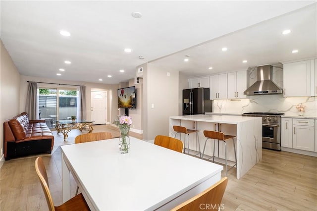 dining room featuring light wood-style flooring and recessed lighting