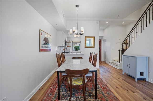 14702 Magnolia Blvd Unit 104, Sherman Oaks, CA 91403 - dining room featuring light wood-type flooring, a chandelier, stairway, baseboards, and recessed lighting
