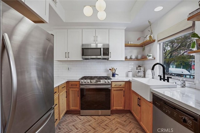 14702 Magnolia Blvd Unit 104, Sherman Oaks, CA 91403 - kitchen featuring appliances with stainless steel finishes, a sink, open shelves, decorative backsplash, and a raised ceiling