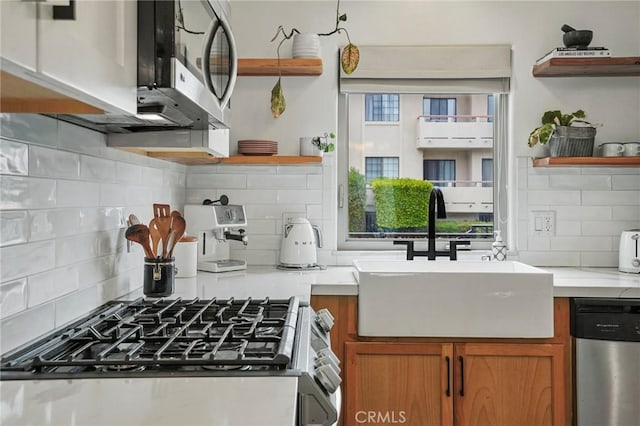 14702 Magnolia Blvd Unit 104, Sherman Oaks, CA 91403 - kitchen with open shelves, a sink, appliances with stainless steel finishes, backsplash, and brown cabinets