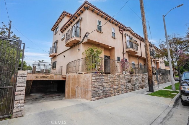 14702 Magnolia Blvd Unit 104, Sherman Oaks, CA 91403 - view of front of home with a balcony, fence, stucco siding, and a gate