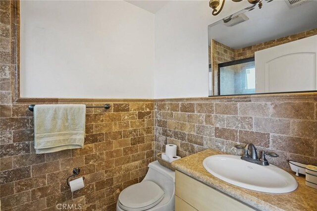 14702 Magnolia Blvd Unit 104, Sherman Oaks, CA 91403 - bathroom featuring toilet, tile walls, a shower stall, vanity, and a wainscoted wall
