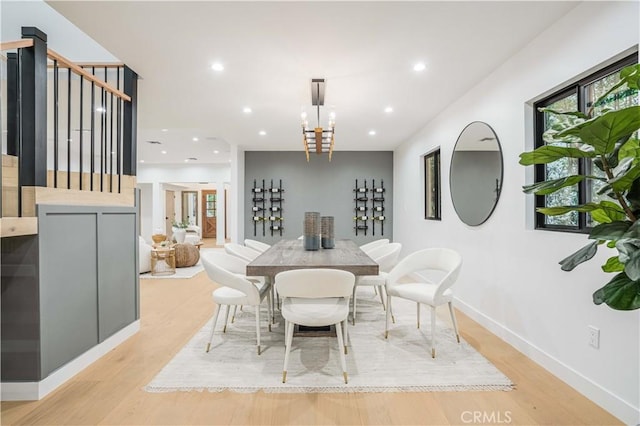 dining space with light wood finished floors, recessed lighting, a chandelier, and baseboards