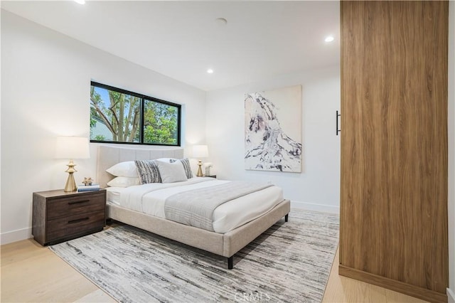 bedroom featuring light wood-style flooring, baseboards, and recessed lighting