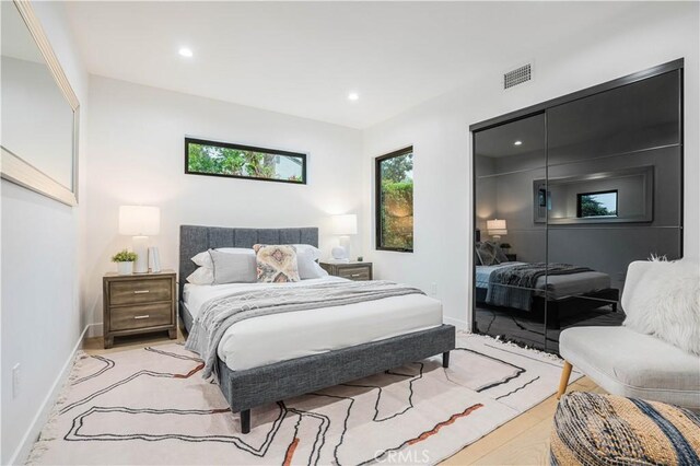 bedroom with a closet, baseboards, and recessed lighting