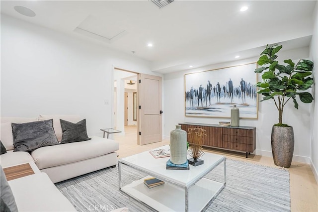 living room with attic access, recessed lighting, and baseboards