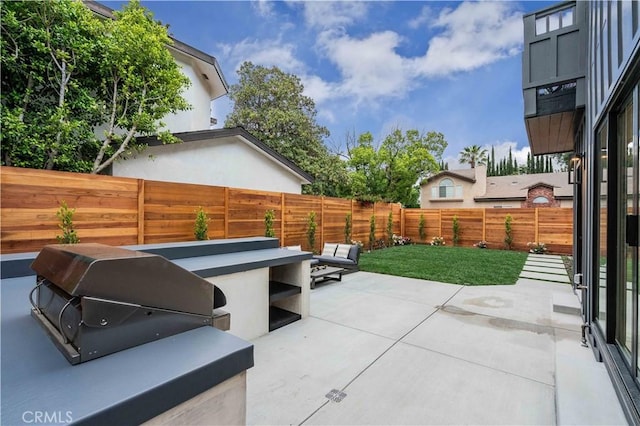 view of patio featuring grilling area and a fenced backyard