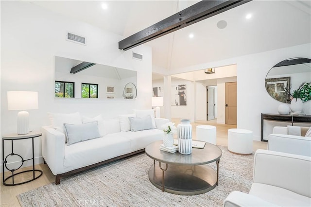 living area with wood finished floors, baseboards, high vaulted ceiling, beamed ceiling, and recessed lighting