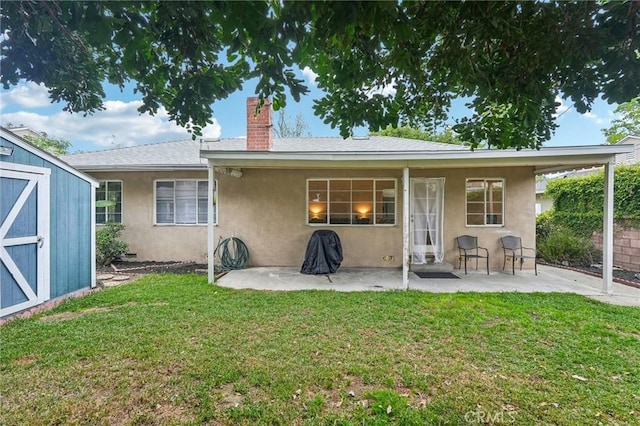 16133 Haldane St, Whittier, CA 90603 - rear view of property featuring a shed, stucco siding, a patio area, a yard, and a chimney