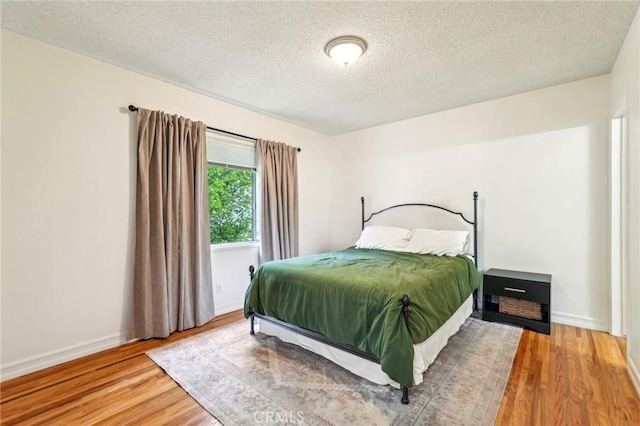 16133 Haldane St, Whittier, CA 90603 - bedroom with wood finished floors, a textured ceiling, and baseboards
