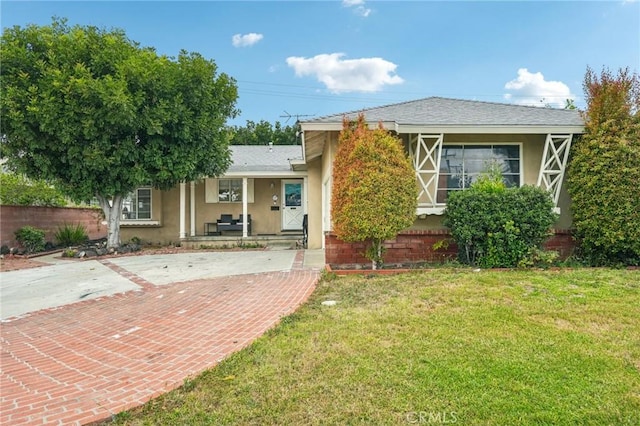 16133 Haldane St, Whittier, CA 90603 - view of front of home with a porch, stucco siding, and a front lawn